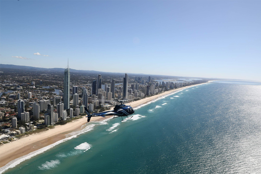 Gold Coast Helicopter Flight - Experience the excitement of a Gold Coast Helicopter Flight as you soar above the stunning coastline, golden beaches, and iconic landmarks. Enjoy breathtaking aerial views of the Broadwater, lush hinterland, and Southern Gold Coast on this unforgettable adventure. Whether you're capturing photos or simply taking in the scenery, this scenic flight offers a unique way to explore the beauty of the Gold Coast from the sky. Gold Coast Helicopter Flight - Image 1 of 5
