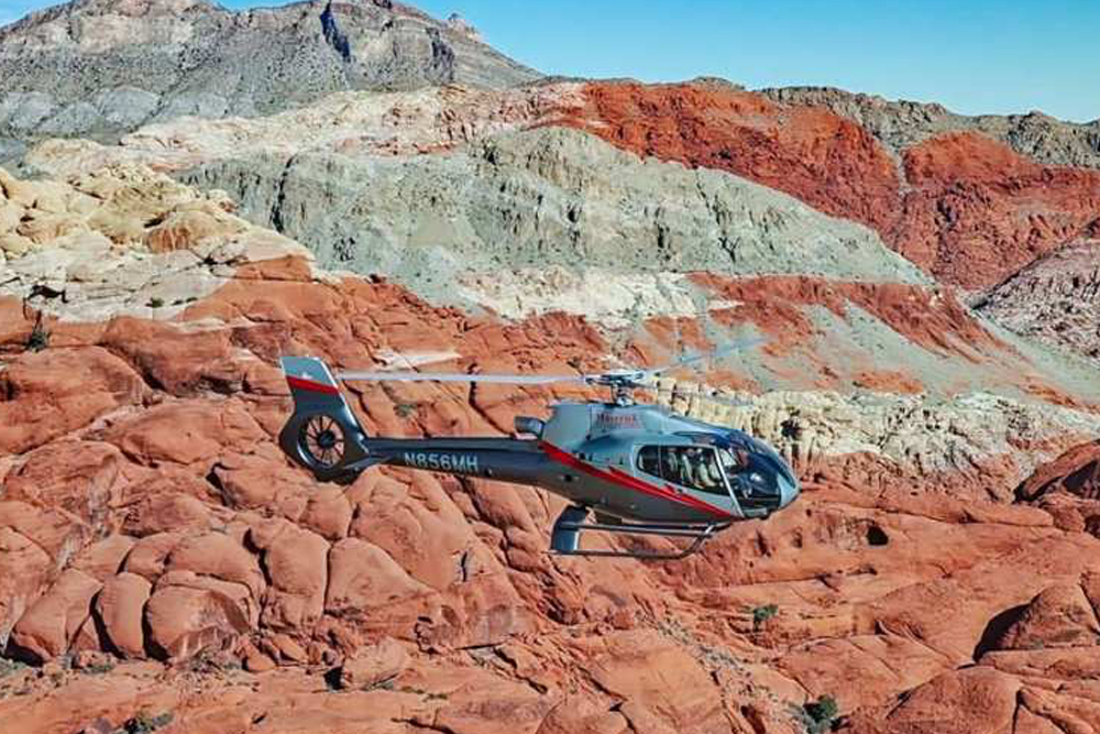 Las Vegas Red Rock Canyon Sunset Helicopter Tour - Experience the beauty of the Las Vegas desert with the Las Vegas Red Rock Canyon Sunset Helicopter Tour. Enjoy breathtaking aerial views of Red Rock Canyon, land at a private scenic viewpoint for a sunset champagne toast, and end your journey with a sparkling night flight over the Las Vegas Strip. Las Vegas Red Rock Canyon Sunset Helicopter Tour - Image 3 of 5
