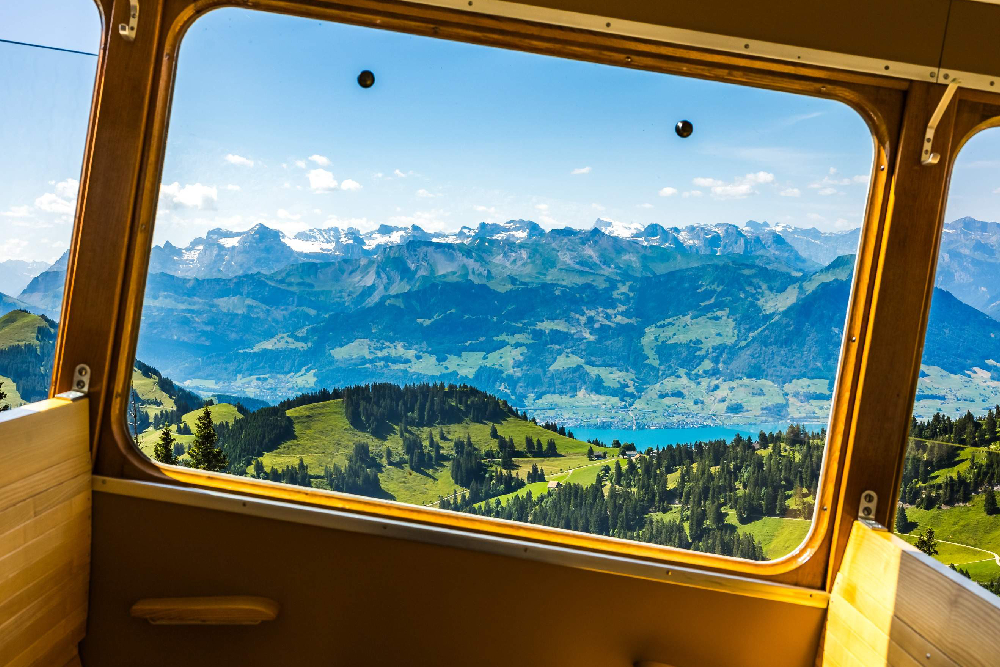 Mount Rigi Queen of the Mountains Ticket - Explore the beauty of Mount Rigi, known as the Queen of the Mountains, with an all-in-one ticket deal. Ride the historic cogwheel train, glide up via cable car, and take in panoramic views of the Swiss Alps. Ideal for day trips from Lucerne or Zurich year-round! Mount Rigi Queen of the Mountains Ticket - Image 2 of 5