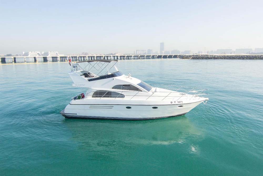Yacht Ride Dubai Marina 48 Ft - (15 Pax) - Explore the world’s most famous artificial island Palm Jumeirah, Atlantis the Palm, Burj Al Arab, Dubai Sky Line, and beautiful private beaches. The 48 Ft Yacht sophistication and luxuriousness. This yacht has 2 bedrooms with 2 bathrooms and a fully air-conditioned saloon. It has a fly-bridge where you can enjoy the panoramic view of the ocean, a fully equipped mini kitchen to serve your appetite, and complimentary fishing equipment to cath fish and enjoy cooking it on grill. Yacht Ride Dubai Marina 48 Ft - (15 Pax) - Image 1 of 5