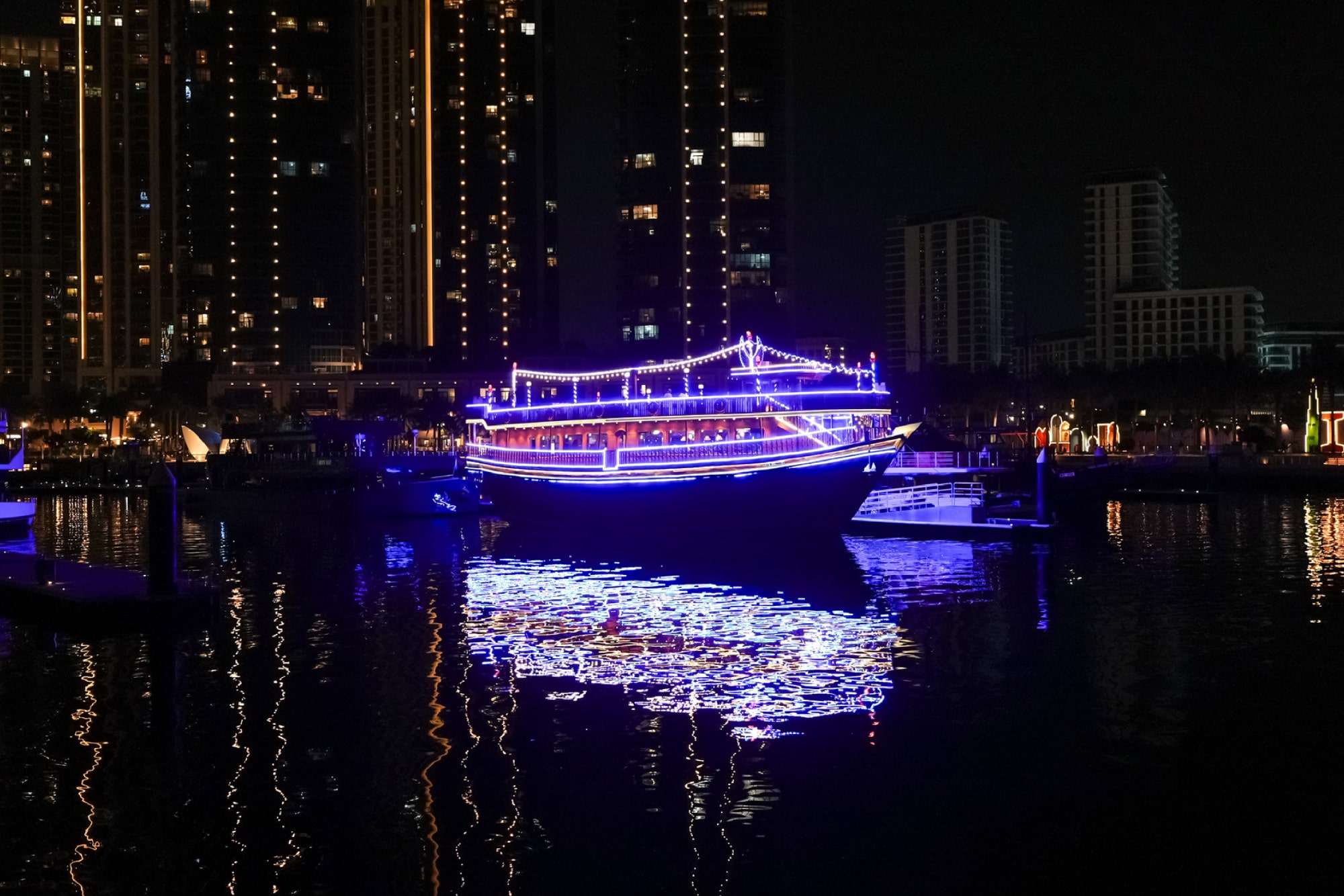 Dubai water Canal Dinner Cruise - Enjoy a 2-hour Dubai Water Canal Dinner Cruise with Dustaku Dhow from Al Jaddaf Marina. Relish an international buffet, watch Tanura & Belly Dance, puppet shows, and soak in Burj Khalifa views. Family-friendly evening with welcome drinks and soft drinks included. Book now for an authentic Arabian night! Dubai water Canal Dinner Cruise - Image 1 of 5