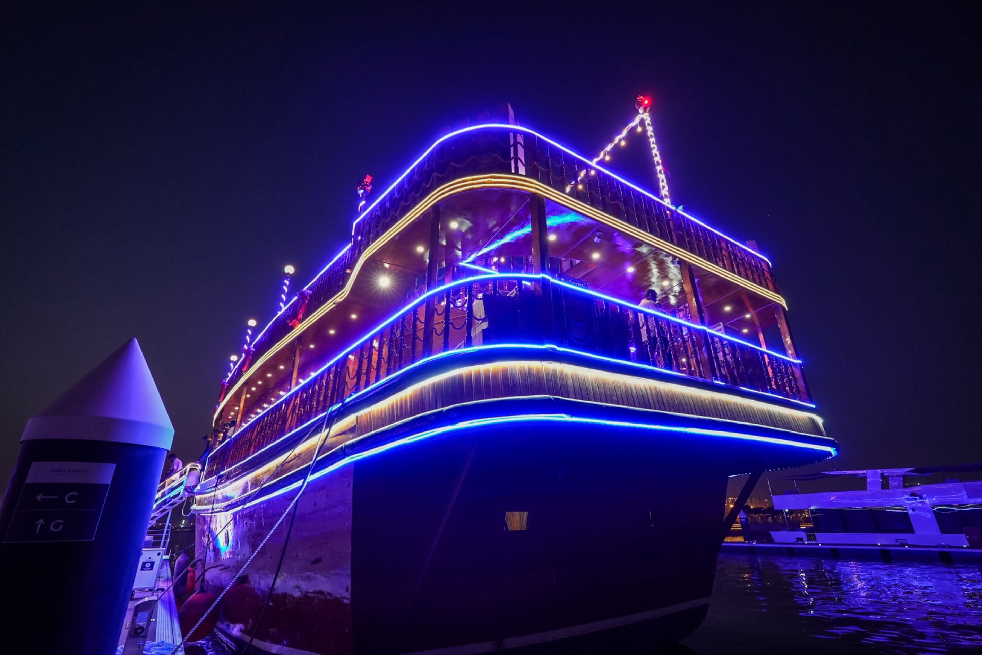 Dubai water Canal Dinner Cruise - Enjoy a 2-hour Dubai Water Canal Dinner Cruise with Dustaku Dhow from Al Jaddaf Marina. Relish an international buffet, watch Tanura & Belly Dance, puppet shows, and soak in Burj Khalifa views. Family-friendly evening with welcome drinks and soft drinks included. Book now for an authentic Arabian night! Dubai water Canal Dinner Cruise - Image 3 of 5