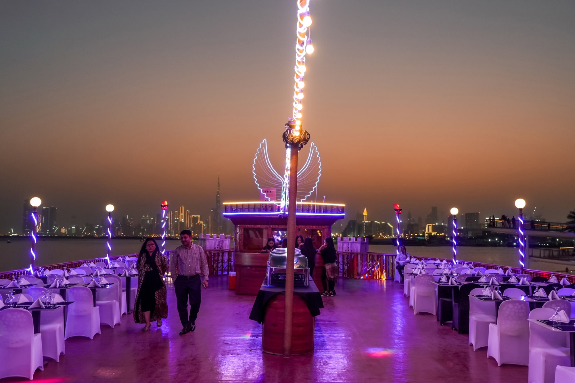 Dubai water Canal Dinner Cruise - Enjoy a 2-hour Dubai Water Canal Dinner Cruise with Dustaku Dhow from Al Jaddaf Marina. Relish an international buffet, watch Tanura & Belly Dance, puppet shows, and soak in Burj Khalifa views. Family-friendly evening with welcome drinks and soft drinks included. Book now for an authentic Arabian night! Dubai water Canal Dinner Cruise - Image 4 of 5