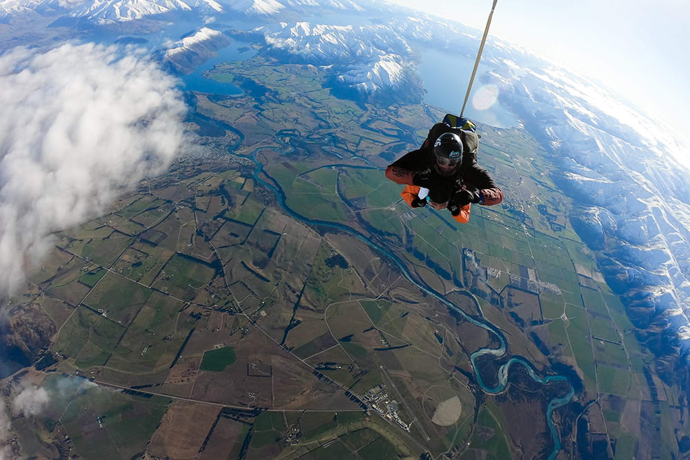 Wanaka Tandem Skydive Over Southern Alps - Experience a Wanaka tandem skydive from 9,000 to 15,000 ft with stunning views of Mt. Cook, Southern Alps, alpine lakes, and the Clutha River. Wanaka Tandem Skydive Over Southern Alps - Image 2 of 5