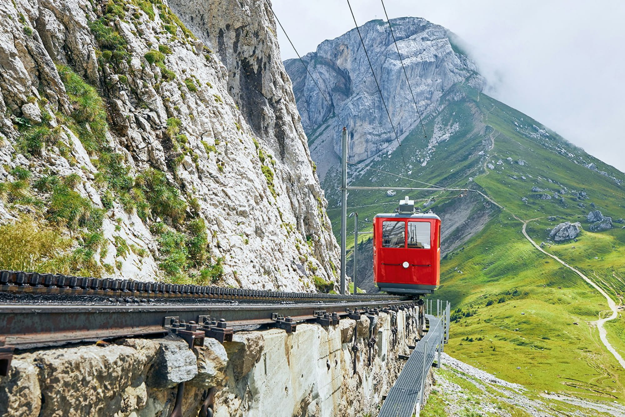 Lucerne tour with Mount Pilatus - Explore Mount Pilatus from Lucerne with a scenic gondola and Dragon Ride cable car. Enjoy breathtaking Swiss Alps views, visit 73 peaks, and discover Lucerne Old Town, Chapel Bridge, and Lion Monument. Lucerne tour with Mount Pilatus - Image 2 of 5