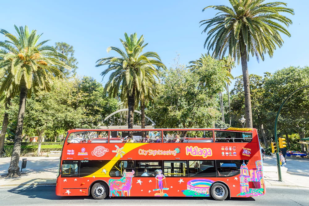 City Sightseeing Malaga Hop-on Hop-off Bus Tour - Explore top attractions with the Málaga 24-hour hop-on hop-off bus tour. Enjoy flexible travel, panoramic city views, and multilingual audio commentary across 14 key stops. City Sightseeing Malaga Hop-on Hop-off Bus Tour - Image 1 of 5