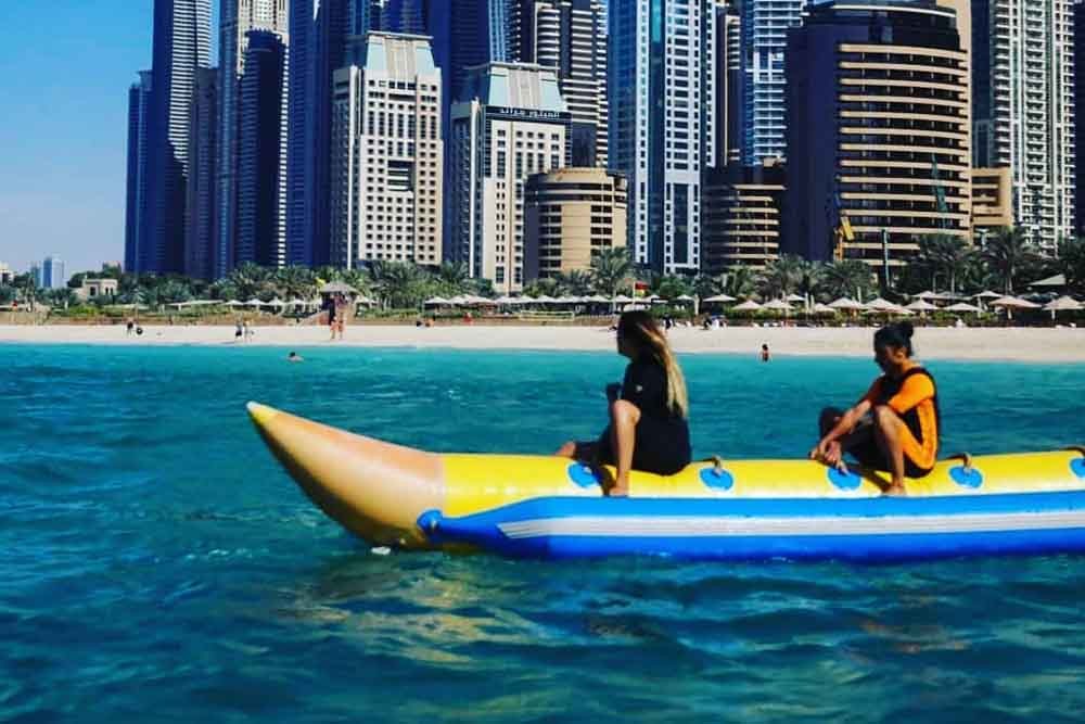 Banana Boat Ride Dubai - Banana ride makes you feel the vibe of a riding a stream ski. Most people who pick Banana Vessel ride are adrenaline searchers who have an excursion with family or gathering of friends, as it can oblige gathering of individuals without a moment's delay. Banana pontoon ride is a standout amongst the most usually attempted water exercises on the shorelines in Dubai. Banana Boat Ride Dubai - Image 3 of 5
