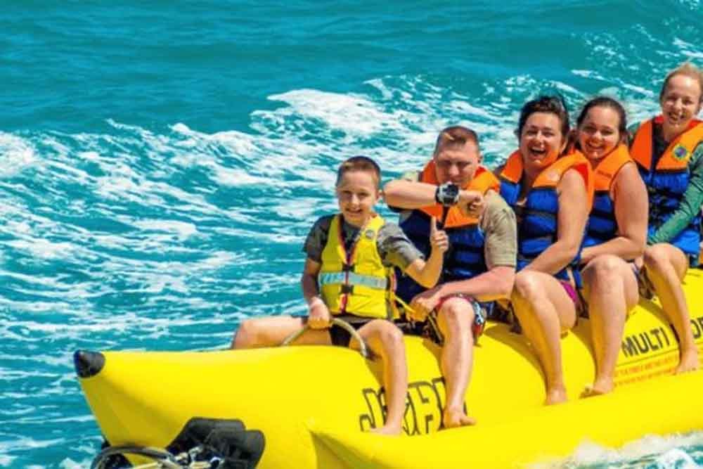 Banana Boat Ride Dubai - Banana ride makes you feel the vibe of a riding a stream ski. Most people who pick Banana Vessel ride are adrenaline searchers who have an excursion with family or gathering of friends, as it can oblige gathering of individuals without a moment's delay. Banana pontoon ride is a standout amongst the most usually attempted water exercises on the shorelines in Dubai. Banana Boat Ride Dubai - Image 5 of 5