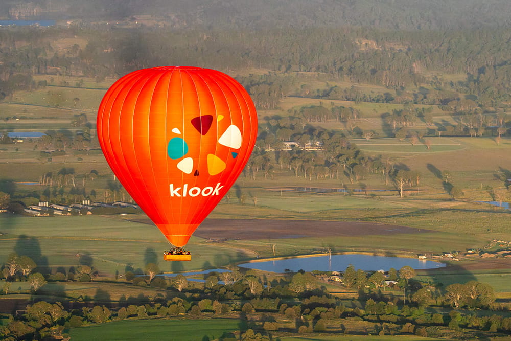 Gold Coast Hot Air Balloon Experience with Sparkling Wine - Enjoy a breathtaking hot air balloon ride over the Gold Coast Hinterland with expert pilots, shared transfers, and sparkling wine. Safe, scenic, and unforgettable half-day experience. Gold Coast Hot Air Balloon Experience with Sparkling Wine - Image 1 of 5