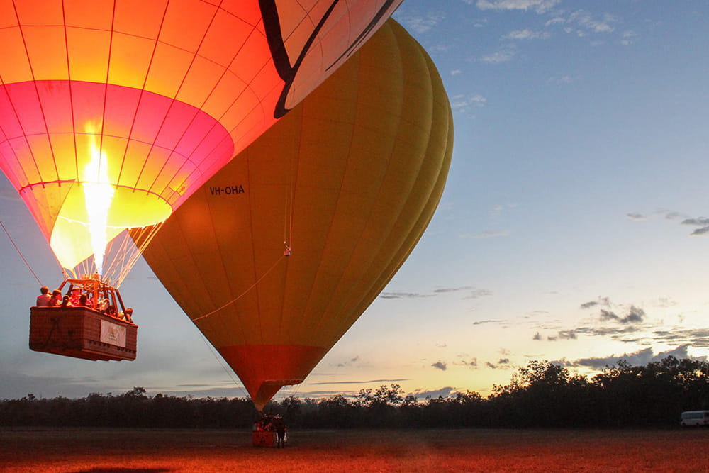 Cairns Hot Air Balloon Flight with 3-Course Meal and Drink - Experience a stunning sunrise hot air balloon ride over Cairns and the Atherton Tablelands. Enjoy scenic views, transfers, photos, bubbly on landing, and a 3-course meal voucher. Cairns Hot Air Balloon Flight with 3-Course Meal and Drink - Image 1 of 5