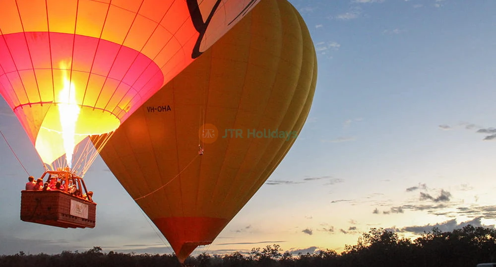 Cairns Hot Air Balloon Flight with 3-Course Meal and Drink - Experience a stunning sunrise hot air balloon ride over Cairns and the Atherton Tablelands. Enjoy scenic views, transfers, photos, bubbly on landing, and a 3-course meal voucher. Cairns Hot Air Balloon Flight with 3-Course Meal and Drink - Image 1 of 5
