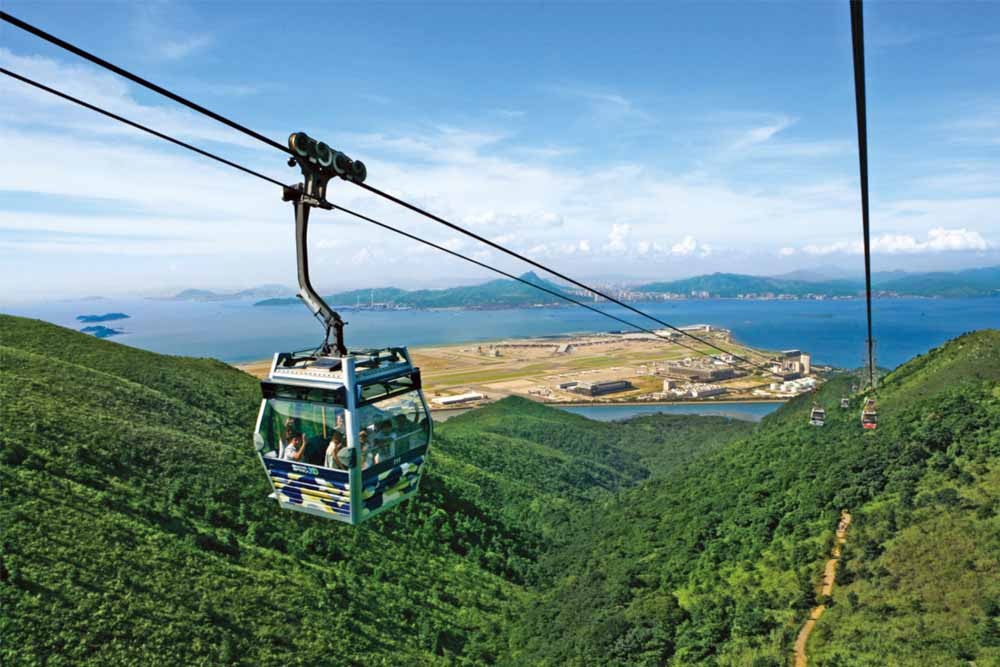 Ngong Ping 360 Cable Car - Hong Kong - Embark on an unforgettable journey to discover the natural wonders and cultural treasures of Hong Kong at Ngong Ping 360 Cable Car. This iconic attraction takes you on a breathtaking ride through the lush mountains and offers panoramic views of the stunning landscape below. Ngong Ping 360 Cable Car - Hong Kong - Image 1 of 5