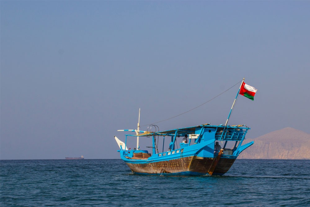 Khasab Tour - Full Day Dhow Cruise With Lunch - Full Day Dhow Cruise to Khor Sham with our traditionally decorated Omani wooden dhows in azure water through a majestic fjord (Khor), surrounded by spectacular mountains and serene remote white sand beaches. At the entrance of the fjord, our guests can enjoy dolphin watching. Khasab Tour - Full Day Dhow Cruise With Lunch - Image 3 of 5