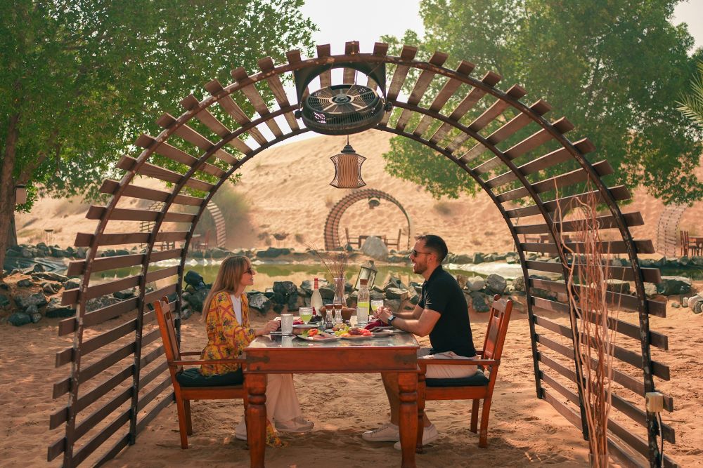Dubai Hot Air Balloon Signature Experience - "Experience a breathtaking sunrise hot air balloon ride over Dubai’s desert with a drone light show, in-flight falcon display, and exclusive views of the Dubai Desert Conservation Reserve. Complete the journey with a Michelin-starred breakfast and a camel ride at a Royal Desert Retreat." Dubai Hot Air Balloon Signature Experience - Image 5 of 5