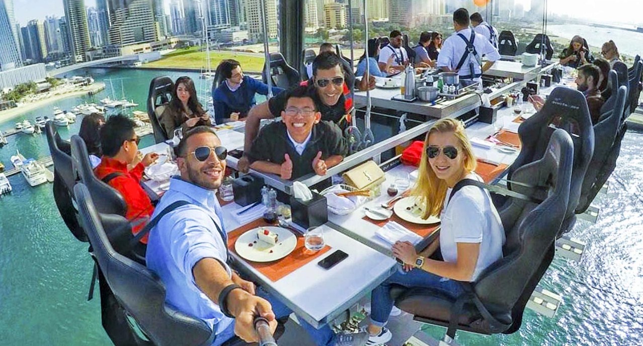 Dinner In The Sky Dubai - Elevate your dining experience in Dubai with Dinner in the Sky. Savor gourmet cuisine suspended above the city's skyline, featuring stunning views of the Burj Khalifa and Palm Jumeirah. An unforgettable blend of gastronomy and adventure awaits! Dinner In The Sky Dubai - Image 1 of 5
