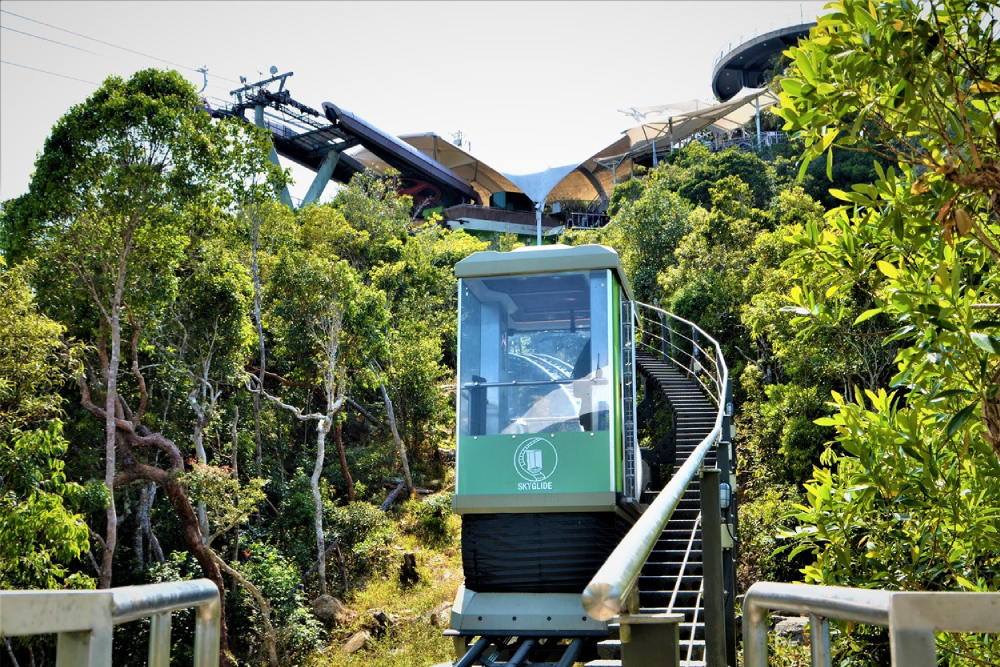 Langkawi SkyCab Cable Car - Experience breathtaking views with the Langkawi SkyCab Cable Car ride to the top of Mount Machinchang. Soar above lush rainforests and enjoy panoramic views of the island. Walk on the iconic SkyBridge and capture stunning photos from the world's longest curved bridge. Discover nearby attractions like SkyDome, SkyRex, and 3D Art Langkawi. The Langkawi SkyCab Cable Car offers a thrilling adventure and unforgettable scenery for all visitors. Don’t miss the chance to ride the Langkawi SkyCab Cable Car on your Langkawi trip. Langkawi SkyCab Cable Car - Image 1 of 5