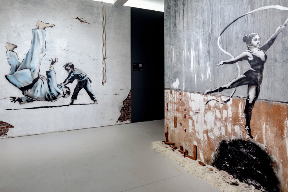 Banksy Museum New York - Explore the world of street art at Banksy Museum New York, home to over 160 recreated works by the legendary anonymous artist. Admire life-sized replicas of iconic pieces like Girl With Balloon and Rage, Flower Thrower at Banksy Museum New York. Dive into the powerful messages of satire and social commentary that define his art. Located in the historic Oltarsh Building, Banksy Museum New York offers an immersive experience for art lovers and fans of urban culture. Visit Banksy Museum New York for a journey into the mind of a street art legend! Banksy Museum New York - Image 3 of 5