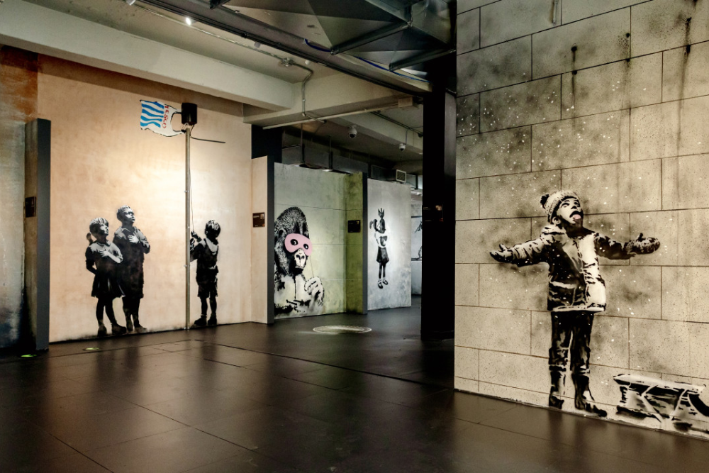 Banksy Museum New York - Explore the world of street art at Banksy Museum New York, home to over 160 recreated works by the legendary anonymous artist. Admire life-sized replicas of iconic pieces like Girl With Balloon and Rage, Flower Thrower at Banksy Museum New York. Dive into the powerful messages of satire and social commentary that define his art. Located in the historic Oltarsh Building, Banksy Museum New York offers an immersive experience for art lovers and fans of urban culture. Visit Banksy Museum New York for a journey into the mind of a street art legend! Banksy Museum New York - Image 4 of 5