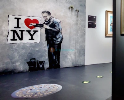 Banksy Museum New York - Explore the world of street art at Banksy Museum New York, home to over 160 recreated works by the legendary anonymous artist. Admire life-sized replicas of iconic pieces like Girl With Balloon and Rage, Flower Thrower at Banksy Museum New York. Dive into the powerful messages of satire and social commentary that define his art. Located in the historic Oltarsh Building, Banksy Museum New York offers an immersive experience for art lovers and fans of urban culture. Visit Banksy Museum New York for a journey into the mind of a street art legend! Banksy Museum New York - Image 5 of 5