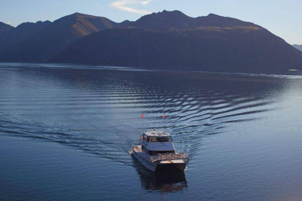 1 Hour Happy Hour Cruise - Lake Wanaka - Unwind with a 1-hour Happy Hour Cruise on Lake Wanaka, where stunning mountain views surround you. Enjoy a complimentary drink and indulge in $6 beverages, paired perfectly with complimentary cheese boards. Relax aboard a luxurious 57-foot catamaran with spacious indoor and outdoor areas. Friendly local crew ensure a memorable and personalized experience on this scenic adventure. 1 Hour Happy Hour Cruise - Lake Wanaka - Image 3 of 5