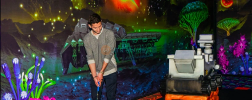 Blacklight Mini Golf at American Dream - Experience the glow-in-the-dark fun of Blacklight Mini Golf at American Dream! Challenge yourself on an exciting 18-hole course with unique obstacles and vibrant neon artwork. Capture memorable moments in this immersive and interactive mini golf adventure. Book your Blacklight Mini Golf ticket now for an unforgettable experience! Blacklight Mini Golf at American Dream - Image 3 of 5