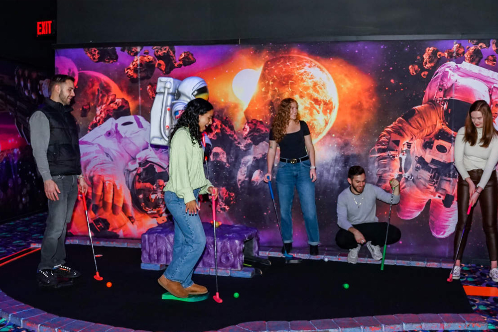 Blacklight Mini Golf at American Dream - Experience the glow-in-the-dark fun of Blacklight Mini Golf at American Dream! Challenge yourself on an exciting 18-hole course with unique obstacles and vibrant neon artwork. Capture memorable moments in this immersive and interactive mini golf adventure. Book your Blacklight Mini Golf ticket now for an unforgettable experience! Blacklight Mini Golf at American Dream - Image 4 of 5