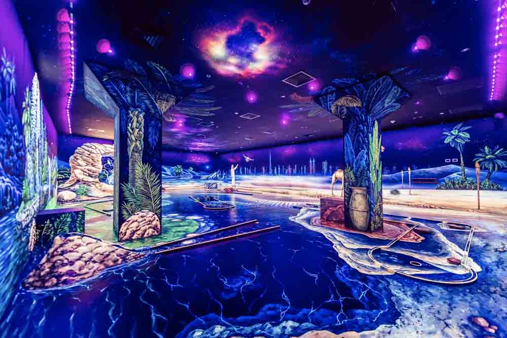 3D Blacklight Minigolf Dubai Tickets - We transport you to a unique black-light indoor minigolf setting the floor, walls, and ceilings of the entire course are beautified with bright and colorful images, hand-painted by the world's best 3d artists. 3D Blacklight Minigolf on a Galactic Scale. The black-lit minigolf course with glowing balls & space-themed artwork viewed through 3D glasses. 3D Blacklight Minigolf Dubai Tickets - Image 5 of 5
