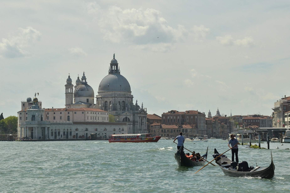 Grand Canal Romantic Gondola Ride in Venice - Enjoy a Grand Canal Romantic Gondola Ride in Venice and glide through historic waterways. Admire stunning palaces, charming bridges, and iconic landmarks from a traditional gondola. Experience the romance of Venice as your gondolier guides you through hidden canals. Book your gondola ride for an unforgettable Venetian adventure. Grand Canal Romantic Gondola Ride in Venice - Image 3 of 5