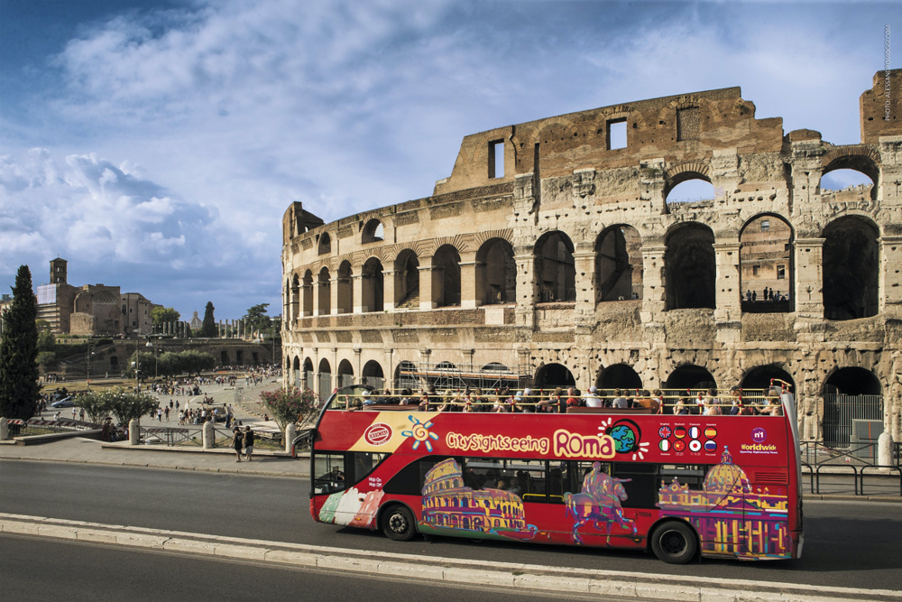 Rome Hop-On Hop-Off Bus by City Sightseeing - Explore Rome with the City Sightseeing Hop-On Hop-Off Bus and visit top attractions at your own pace. Travel on an open-top double-decker bus with stunning views of the Colosseum, Vatican City, and more. Enjoy an audio guide available in multiple languages as you discover Rome’s history and culture. Choose from 24, 48, or 72-hour tickets for a flexible sightseeing experience. Rome Hop-On Hop-Off Bus by City Sightseeing - Image 4 of 5