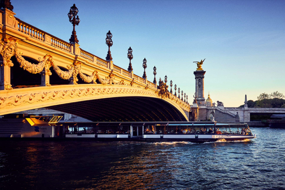Lunch Cruise on the Seine River - Enjoy a Lunch Cruise on the Seine River and discover Paris from the water. This scenic Seine River cruise offers stunning views of famous landmarks like the Eiffel Tower and the Louvre. Savor a traditional three-course meal while cruising along the Seine River. A Seine River lunch cruise is the perfect way to experience Paris in a relaxed and unique way. Book your Lunch Cruise on the Seine River for an unforgettable Paris experience. Lunch Cruise on the Seine River - Image 1 of 5